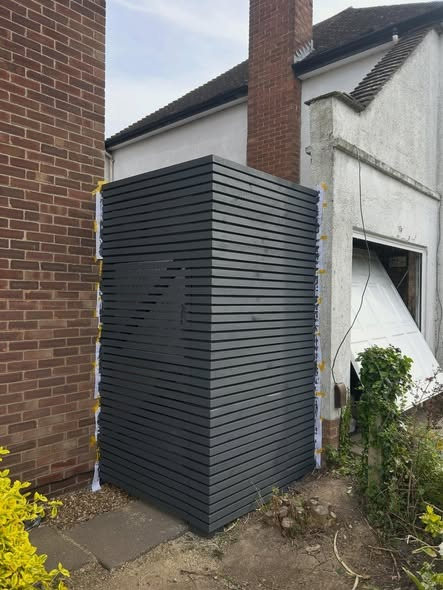 Dark slatted timber cladding enclosure built by CV Carpentry & Construction, Cambridge