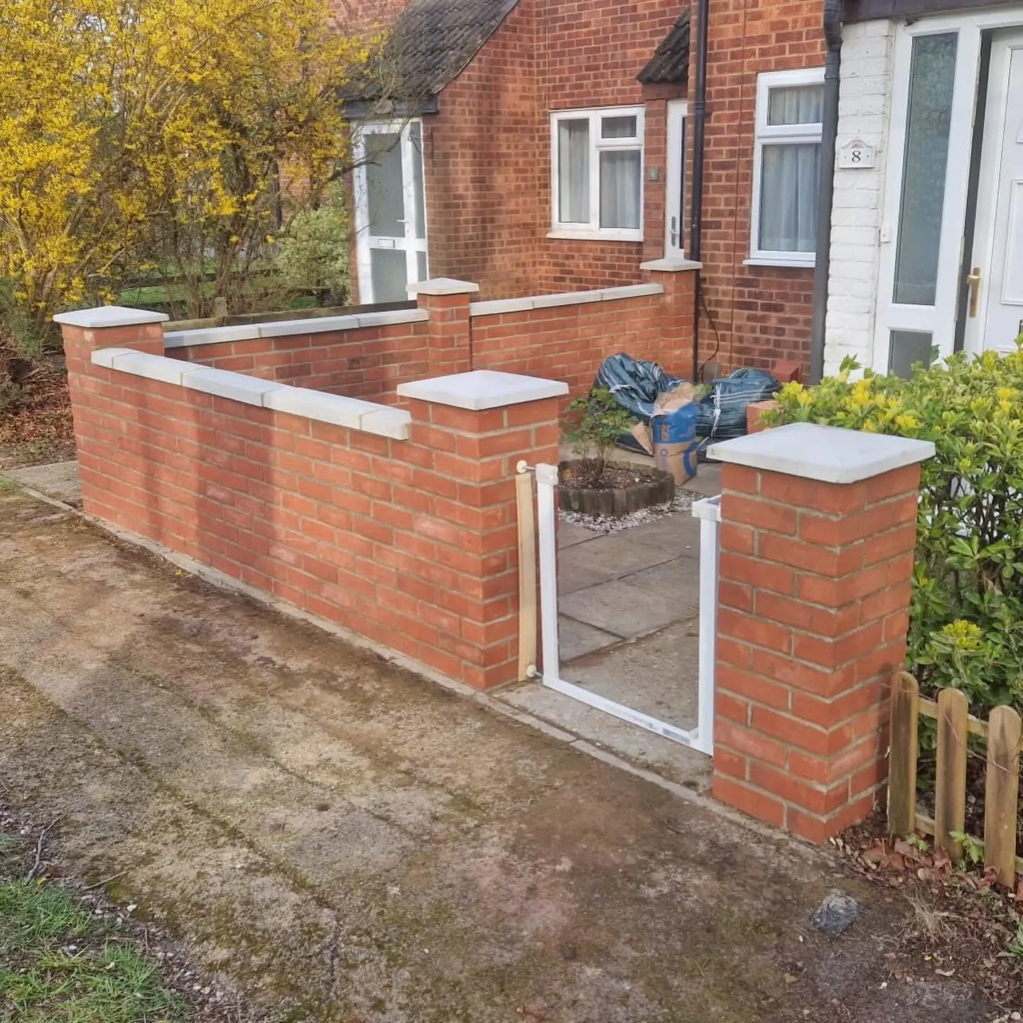 New red brick garden wall with pillars and stone copings built by CV Carpentry & Construction, Cambridge