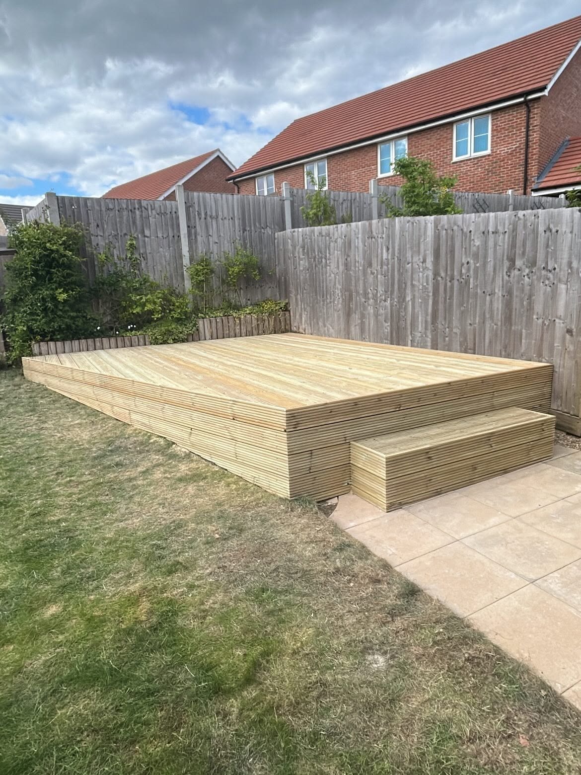 Raised timber decking with steps built in a Cambridge garden by CV Carpentry & Construction